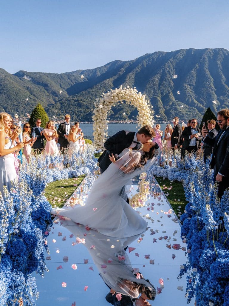 married couple kissing on Lake Como during luxury wedding